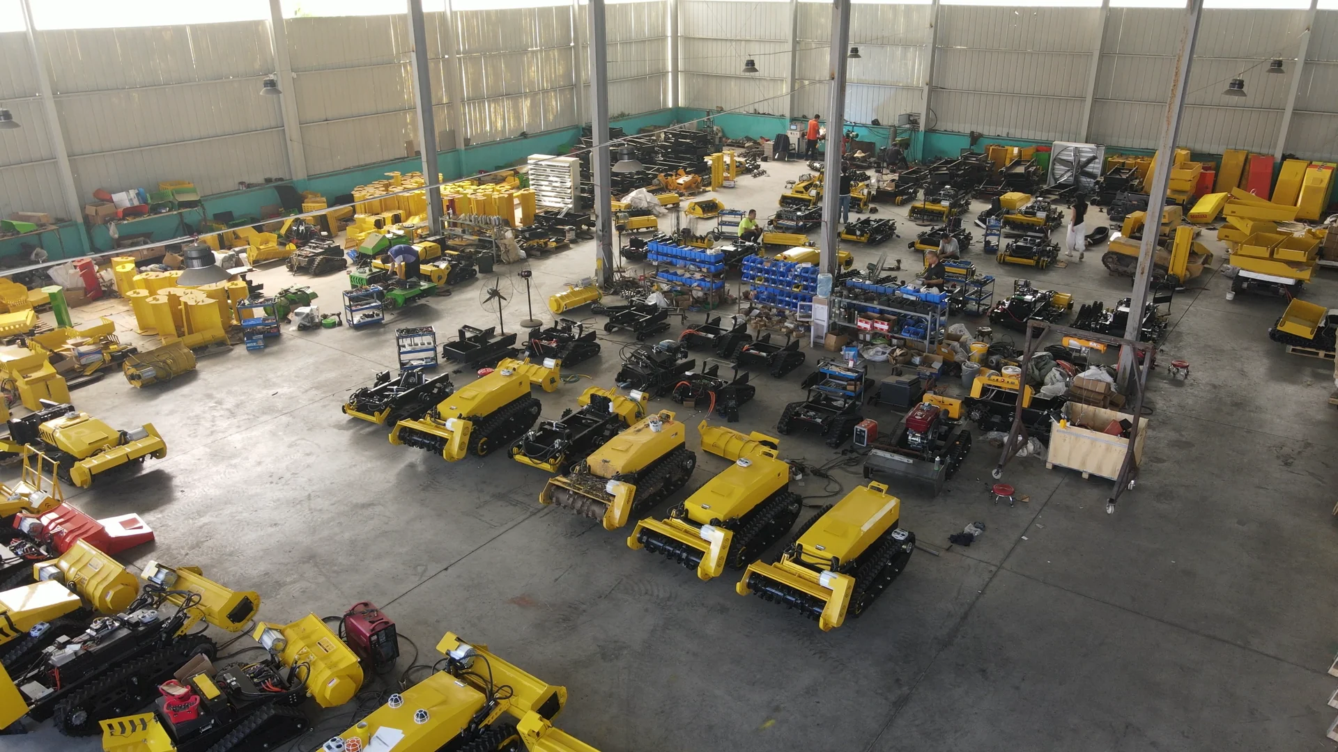 Rows of tracked machines and parts in the assembly workshop.